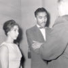 African-American man and white woman talking to white man in suit