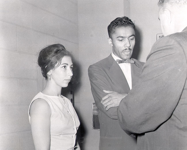 African-American man and white woman talking to white man in suit