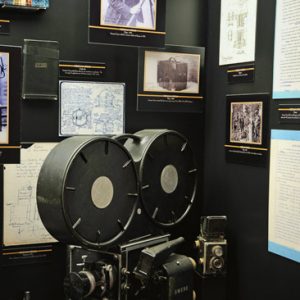 Film camera on display with framed photograph panels