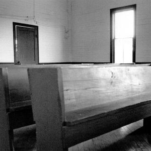 Row of wooden pews in sanctuary room