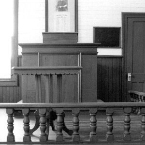 Pulpit inside wooden railing in sanctuary room