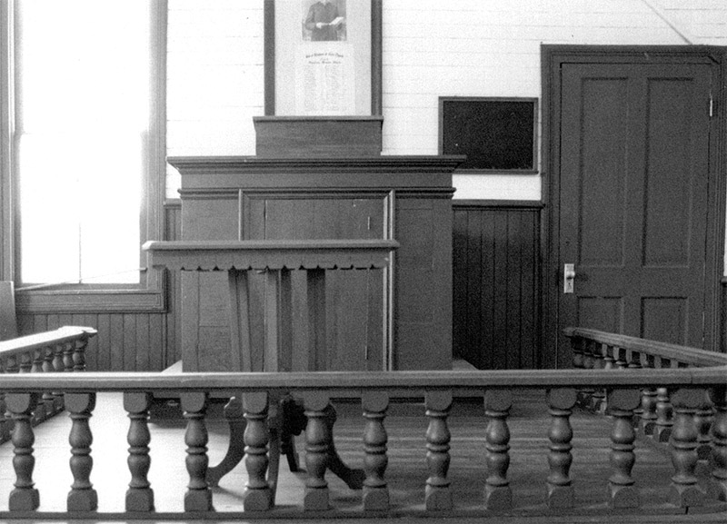 Pulpit inside wooden railing in sanctuary room