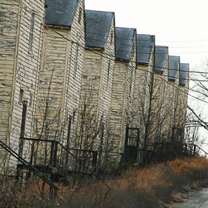 Row of weathered multistory buildings and road