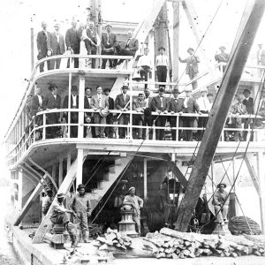 People standing on deck of steamboat
