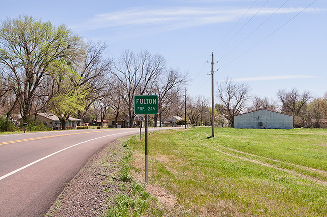 Fulton road sign on two-lane highway