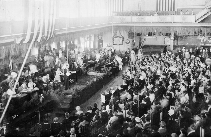 Crowded convention hall with speakers on stage