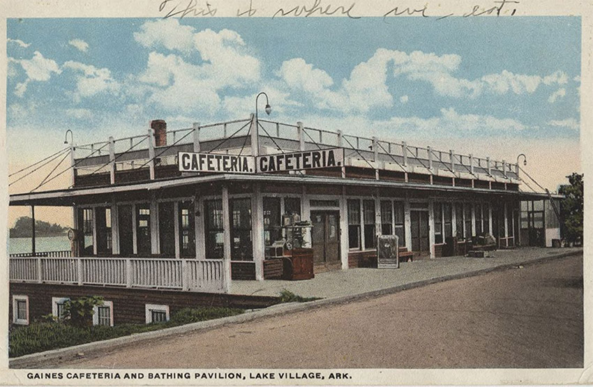 Postcard showing single story building at lakeside