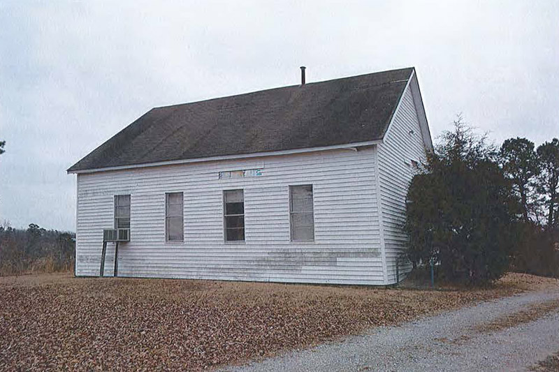 Side view of single story building with wood siding
