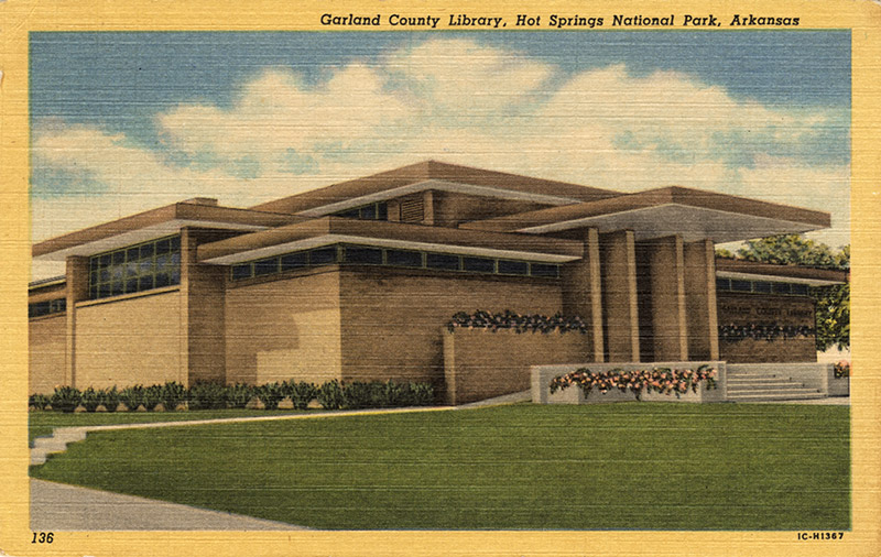 Brick building with flat roofs and covered entrance on post card