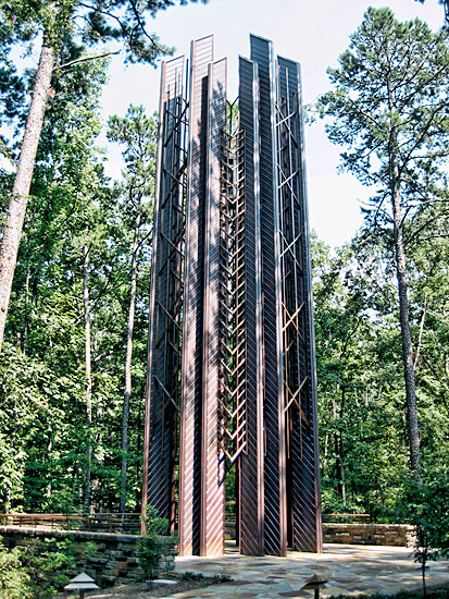 Tower with copper clad steel frame and columns in wooded area