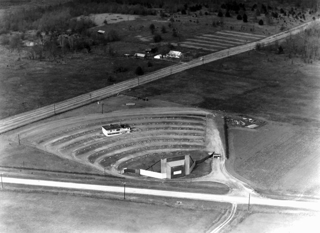 Aerial view of drive-in theater and street with house in the background