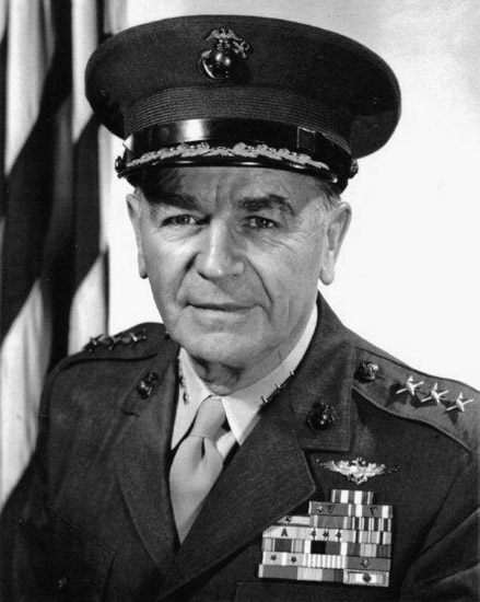 Older white man in military uniform with hat and American flag