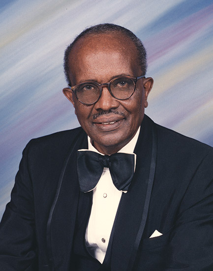 African-American man with mustache in suit and bow tie