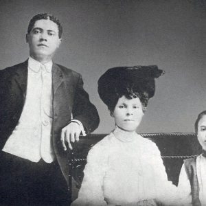 African-American man, woman, and son posing together in formal dress