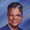 Older African-American woman with glasses in blue top