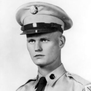 Young white man in military uniform with cap