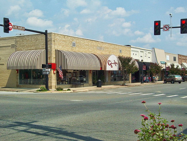 Single-story brick storefront buildings on town street