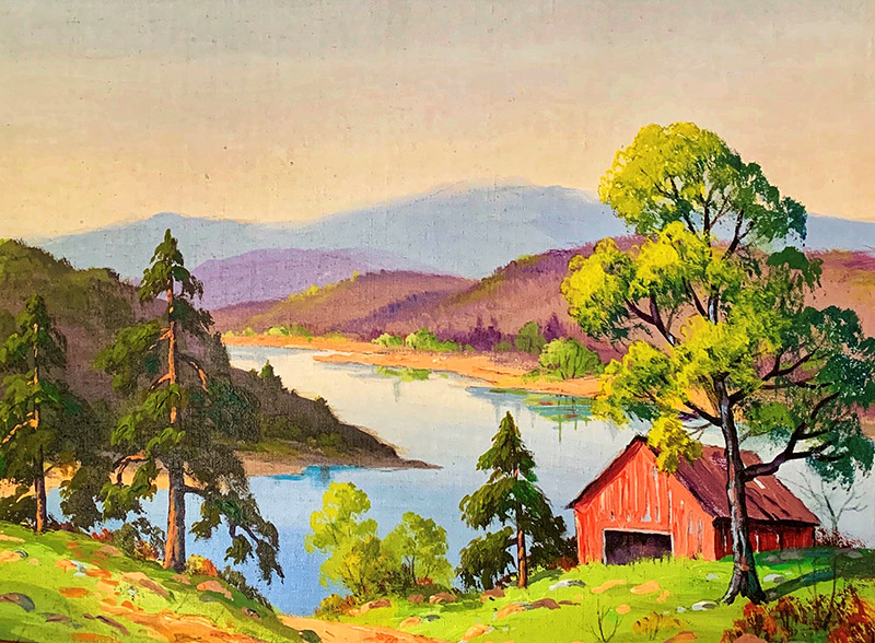 Red barn overlooking lake with mountains in the background