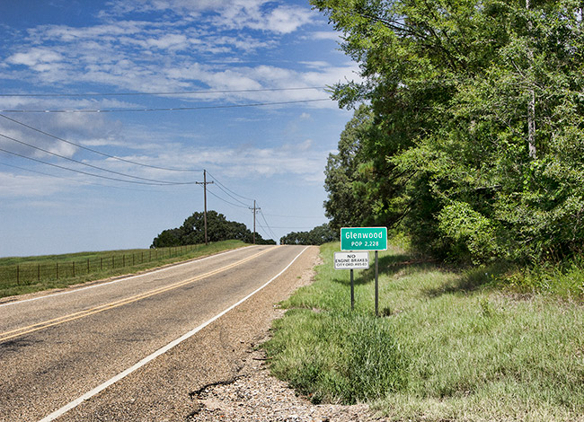 "Glenwood" road sign on two-lane highway