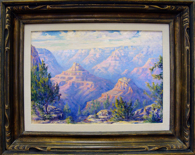 Painting of rock formations in canyon with trees in wooden frame