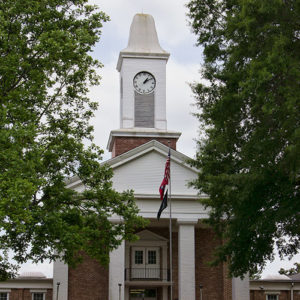 Multistory brick church building with covered entrance and clock tower