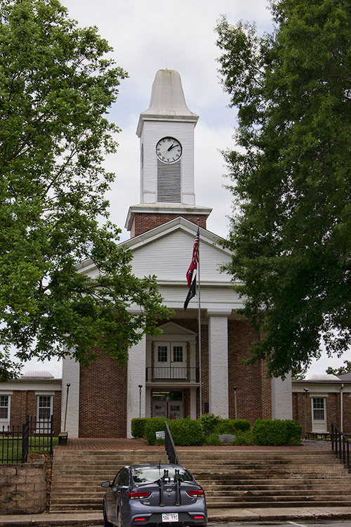 Multistory brick church building with covered entrance and clock tower