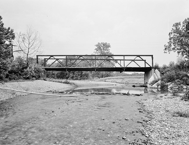 Steel truss bridge over mostly dried up creek