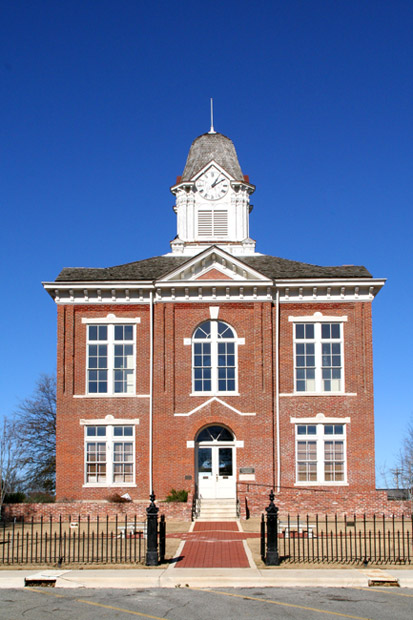 two story brick building with clock tower