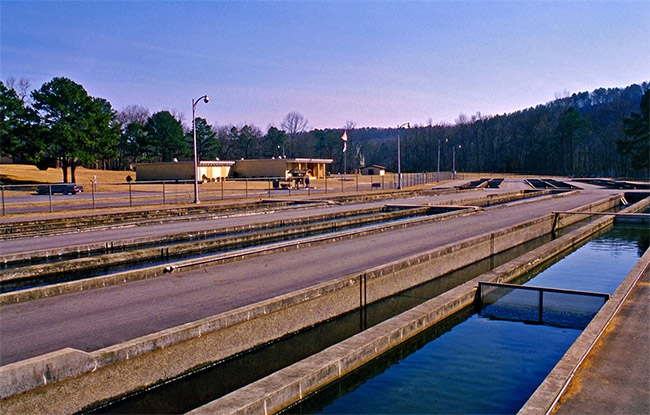 Concrete holding tanks with building and parking lot