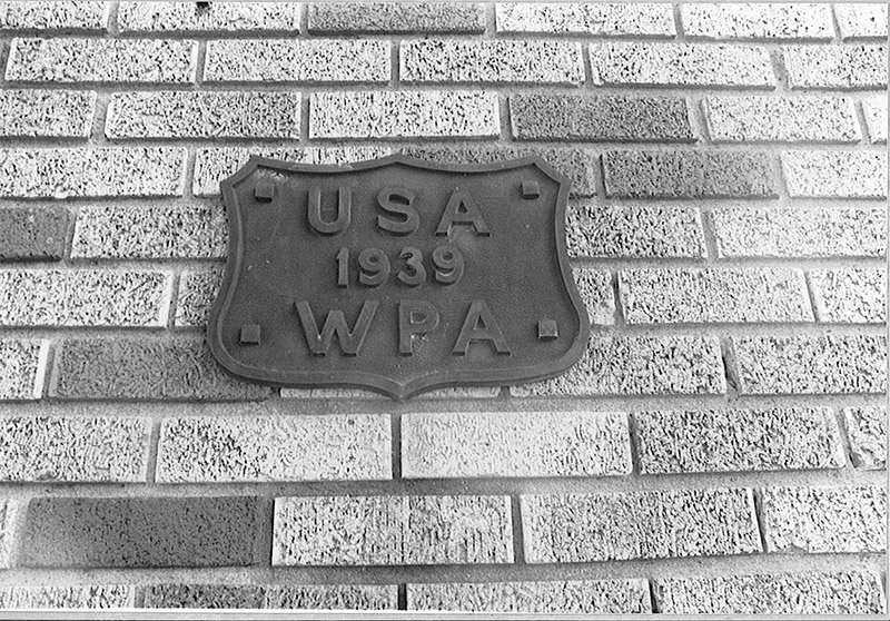 "U.S.A. 1939 W.P.A." badge shaped plaque on brick wall