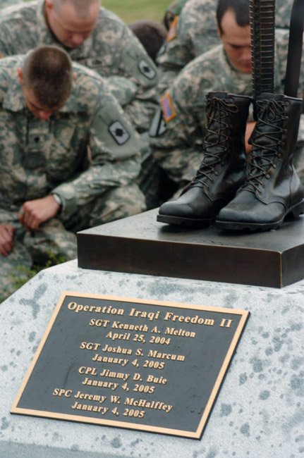 Memorial "Operation Iraqi Freedom 2" with names bronze boot rifle sculpture and kneeling soldiers behind
