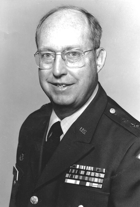 White man in military garb and glasses