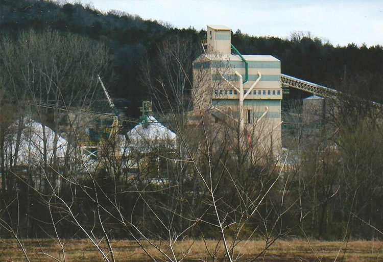 Multistory industrial buildings seen through bare trees