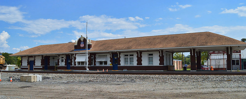 Brick train depot building and train on tracks