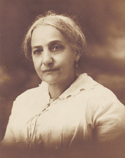 African-American woman in white dress and earrings