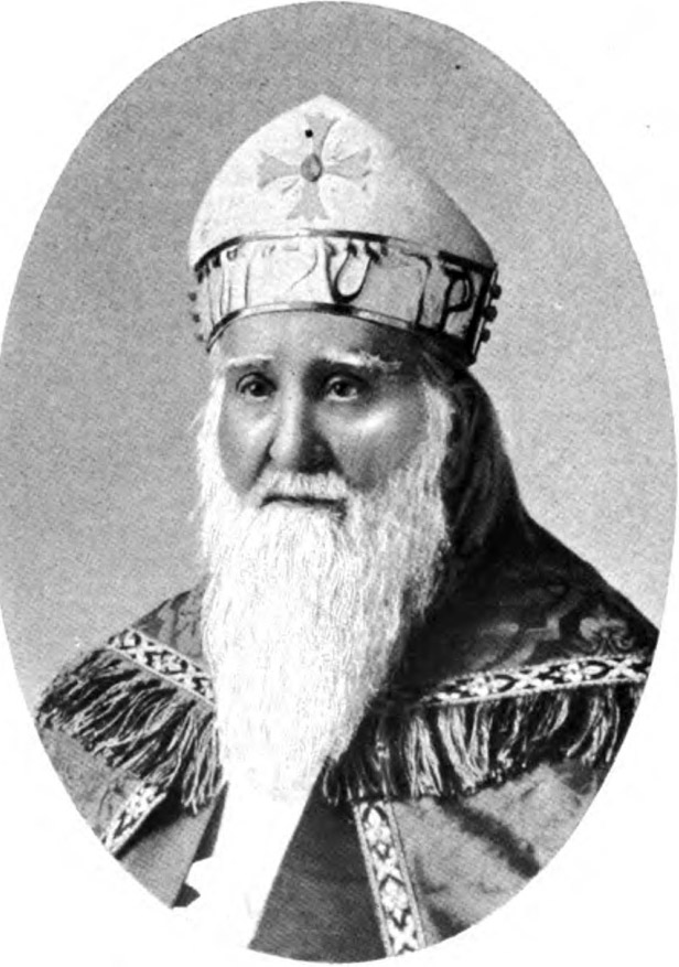 White man with long beard in bishop's robes and miter with cross