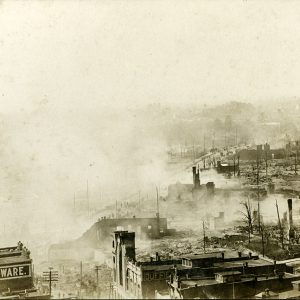 Smoke rising from destroyed buildings on city street