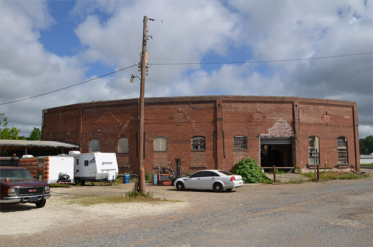 Brick building with parking lot and telephone pole on street