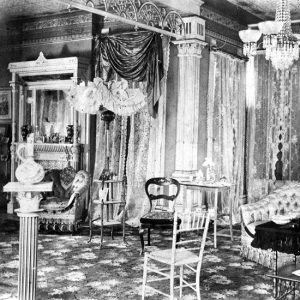Ornate room with fireplace, wood furniture, and tiled ceiling