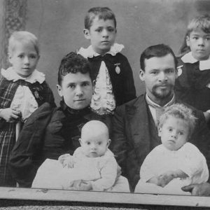 White man woman and their children in group photograph