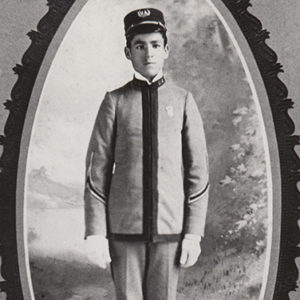 Young white man standing in military uniform in oval frame