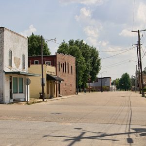 Rural town intersection with brick buildings and power lines