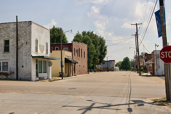 Rural town intersection with brick buildings and power lines