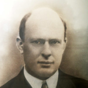 Bald white man in suit and tie
