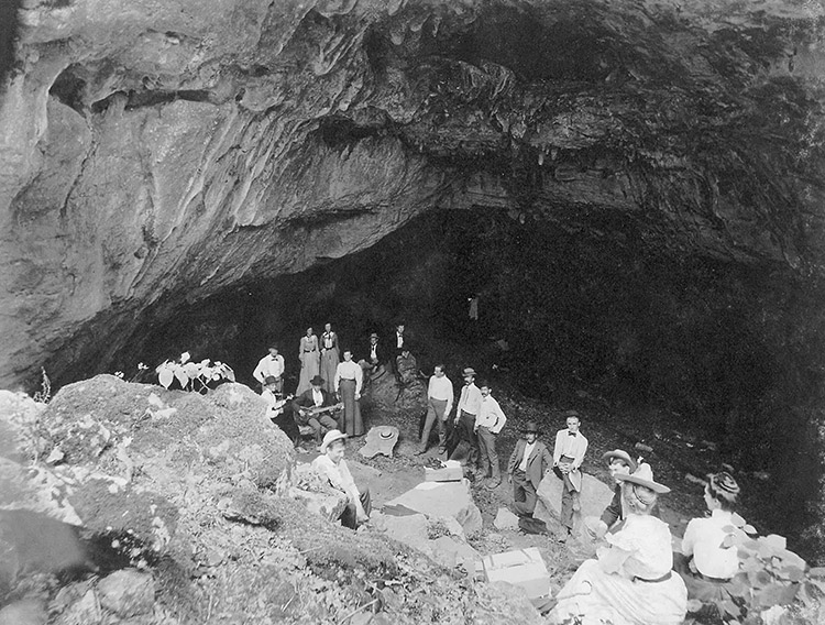 White men and women inside cave