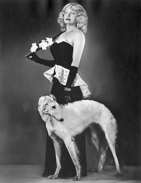 White man wearing a woman's formal black dress with dog