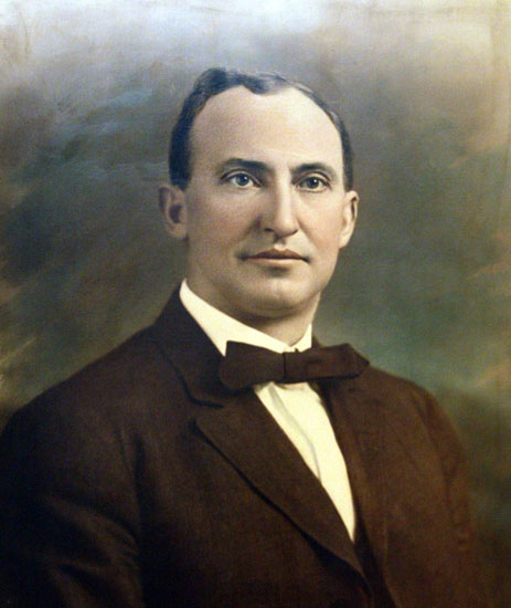 White man in brown suit and bow tie