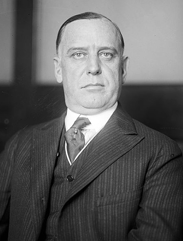 White man in striped suit and tie
