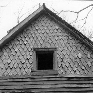 Scale like shingles on cabin with small window