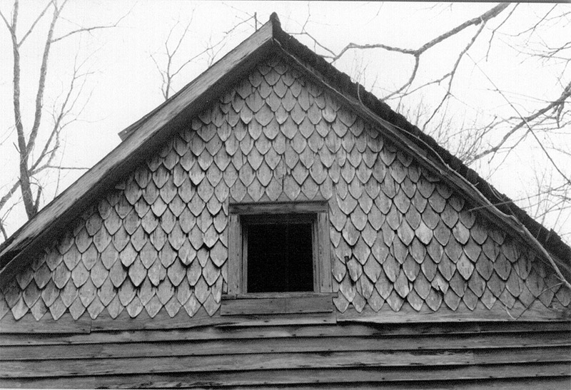 Scale like shingles on cabin with small window